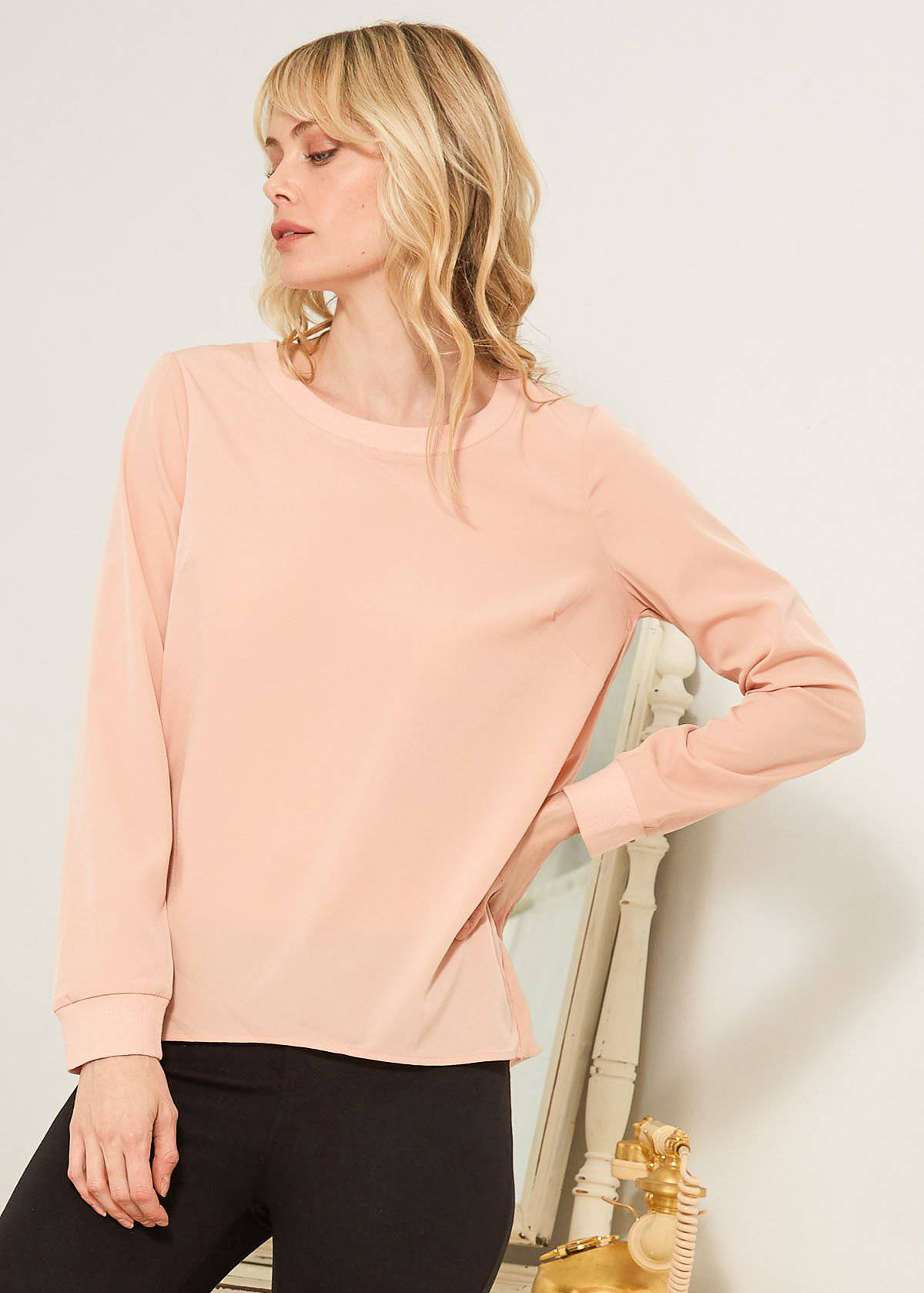 Women's Open Back Crewneck Top in Blush featuring a twisted back design and long sleeves with ribbed cuffs.