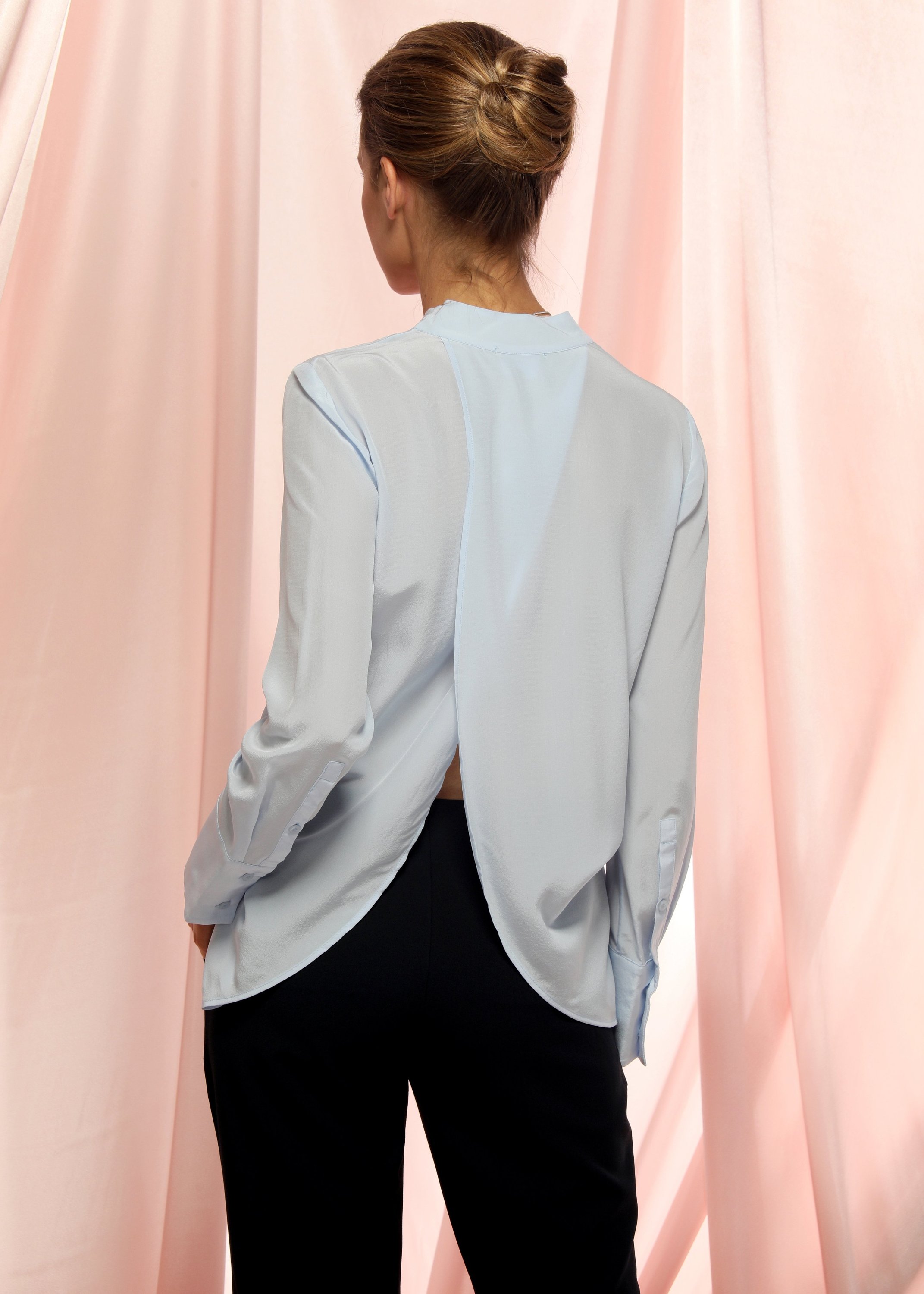 A stylish Women's Pleated V-neck Long Sleeves Blouse in a soft fabric, featuring a pleated design and hidden button fly closure.