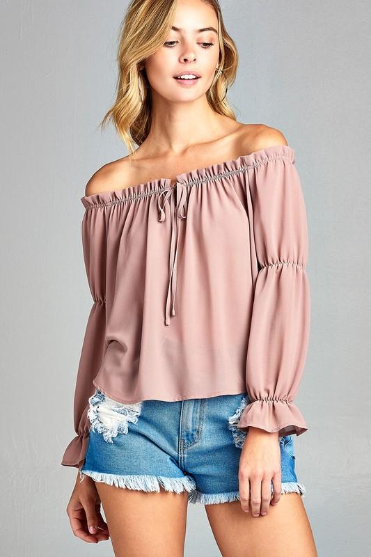 Woman in off-shoulder top and shorts.