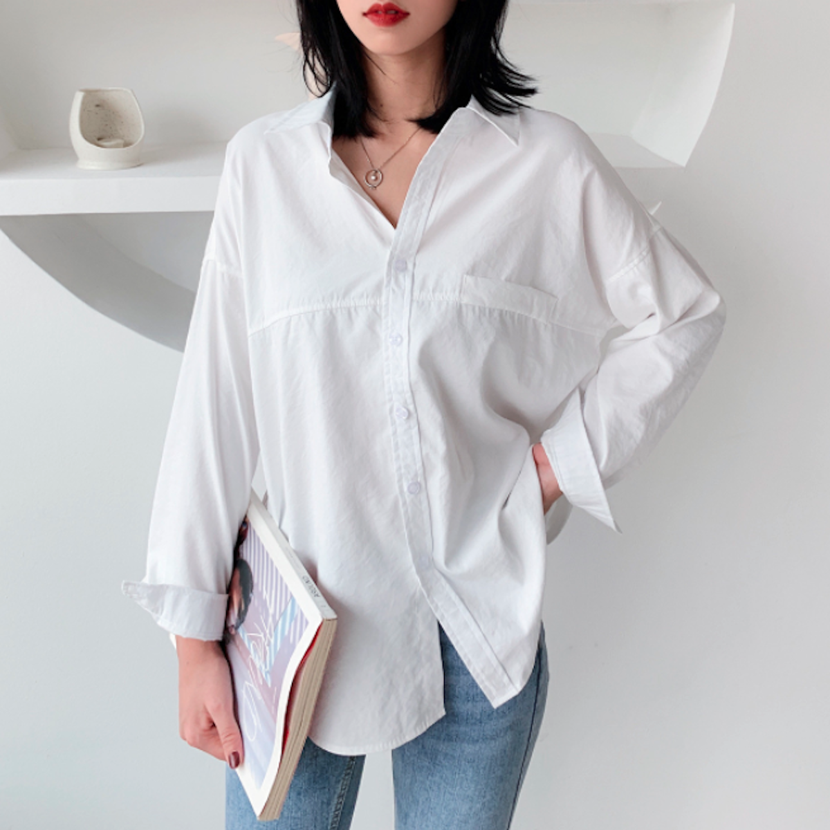 Womens Relaxed Fit Longline Shirt in white, showcasing long sleeves and loose fit design, perfect for casual street fashion.