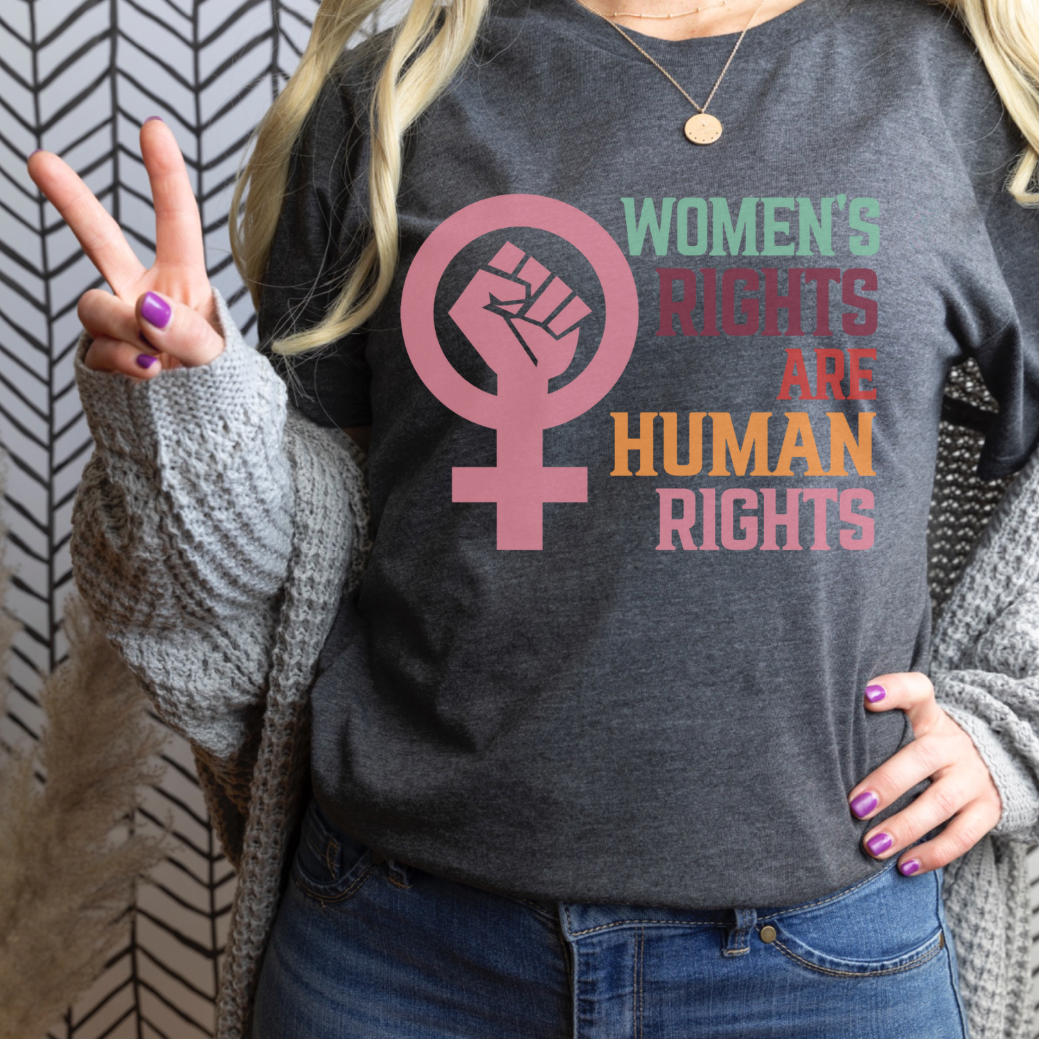 A soft, unisex graphic tee featuring the phrase 'Women's Rights are Human Rights' in bold lettering, made from 100% ring spun cotton.