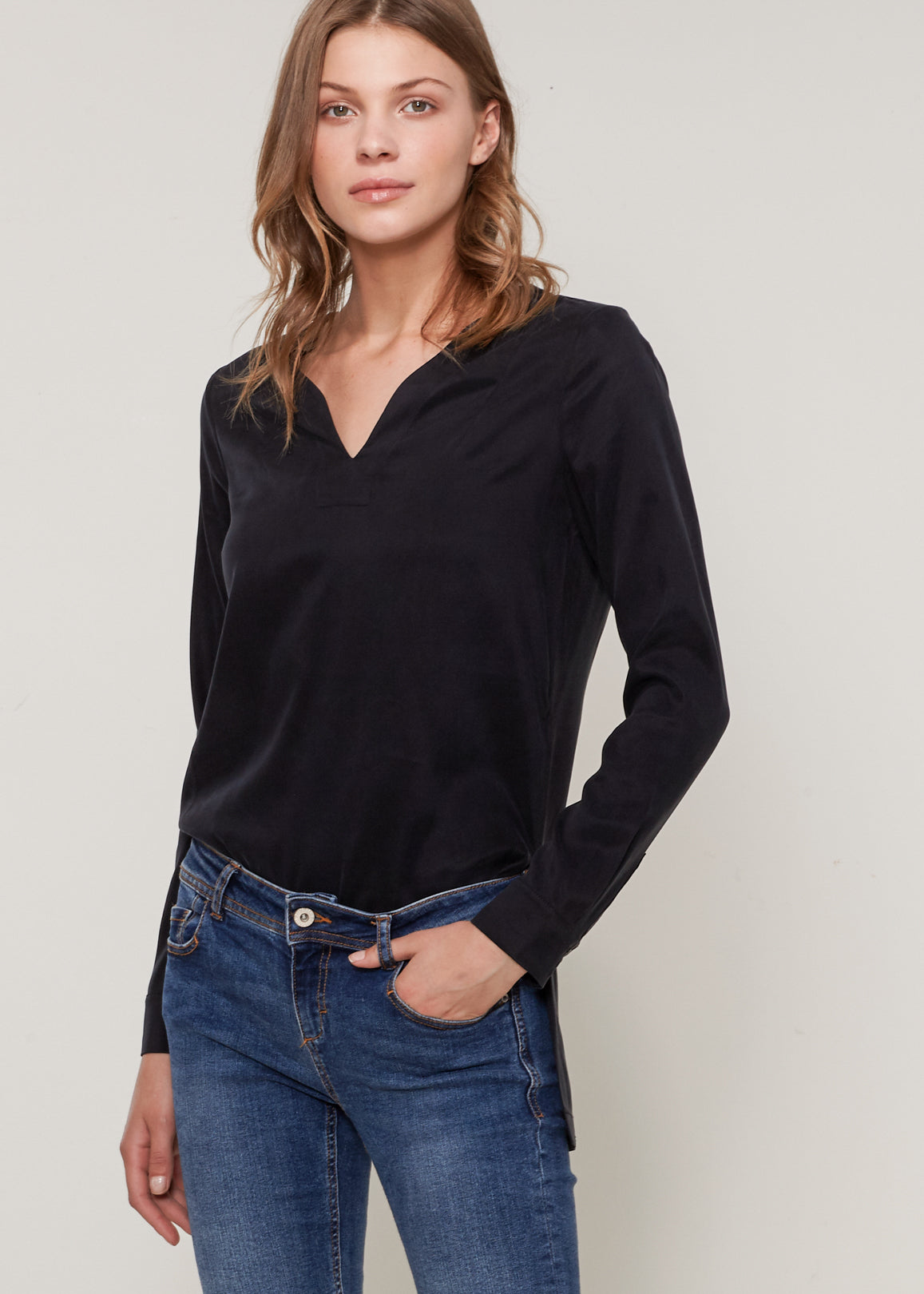 Women's Round Split Neck Hi-Lo Top featuring a stylish hi-lo hem and long sleeves with double button cuffs.