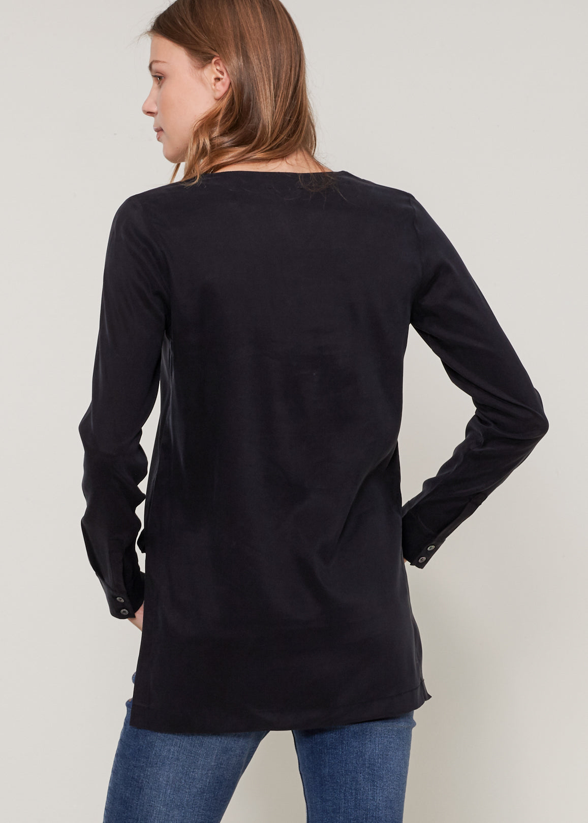 Women's Round Split Neck Hi-Lo Top featuring a stylish hi-lo hem and long sleeves with double button cuffs.