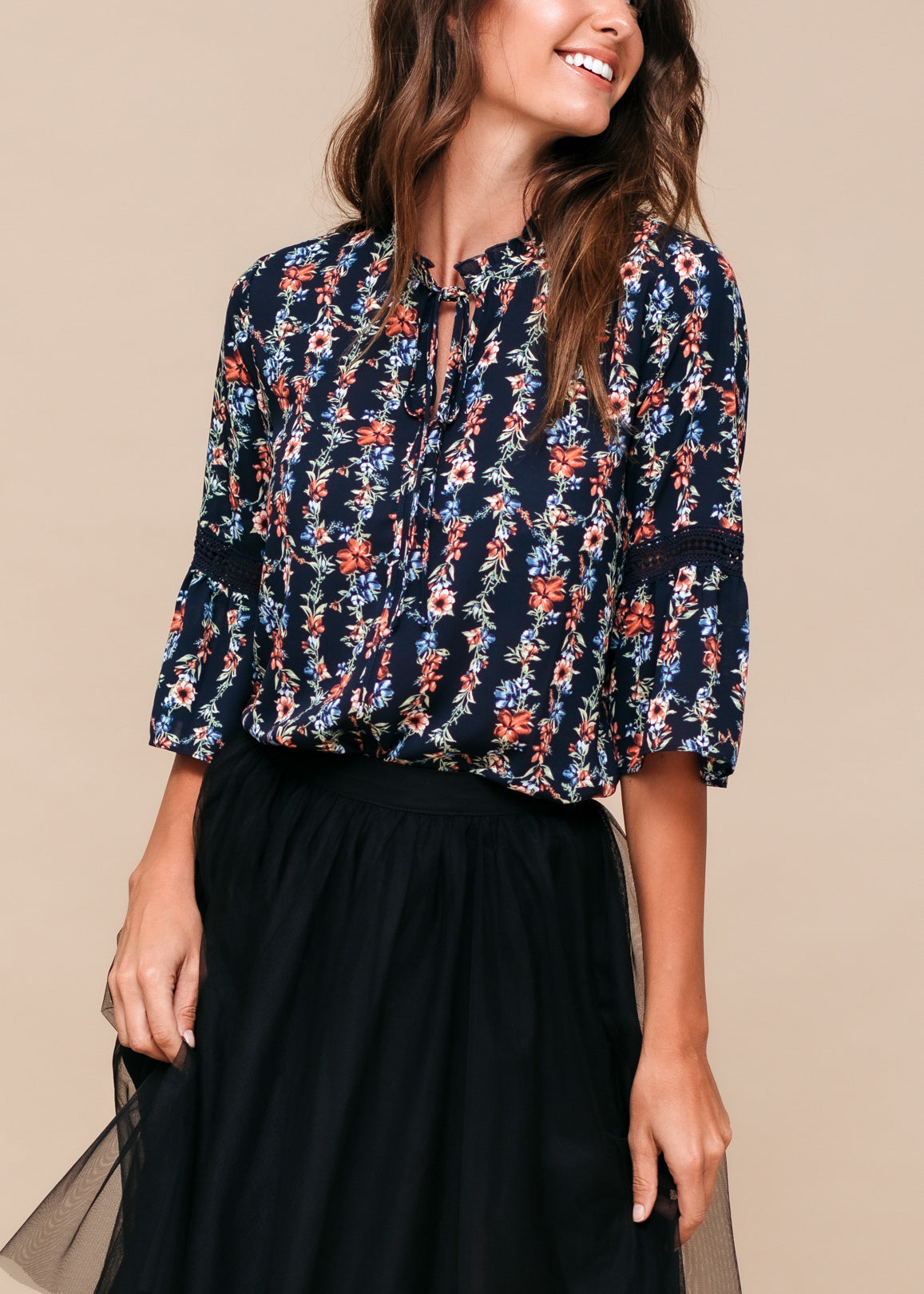 Women's silk tie-neck floral ruffle shirt featuring elegant ruffles and a stylish neck tie.