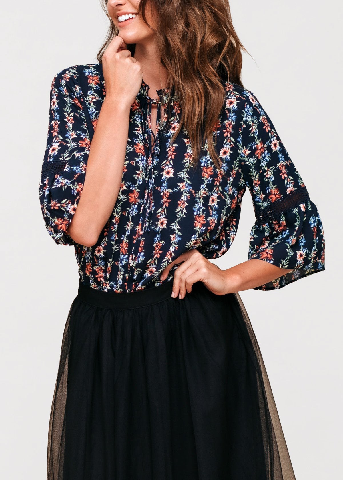 Women's silk tie-neck floral ruffle shirt featuring elegant ruffles and a stylish neck tie.