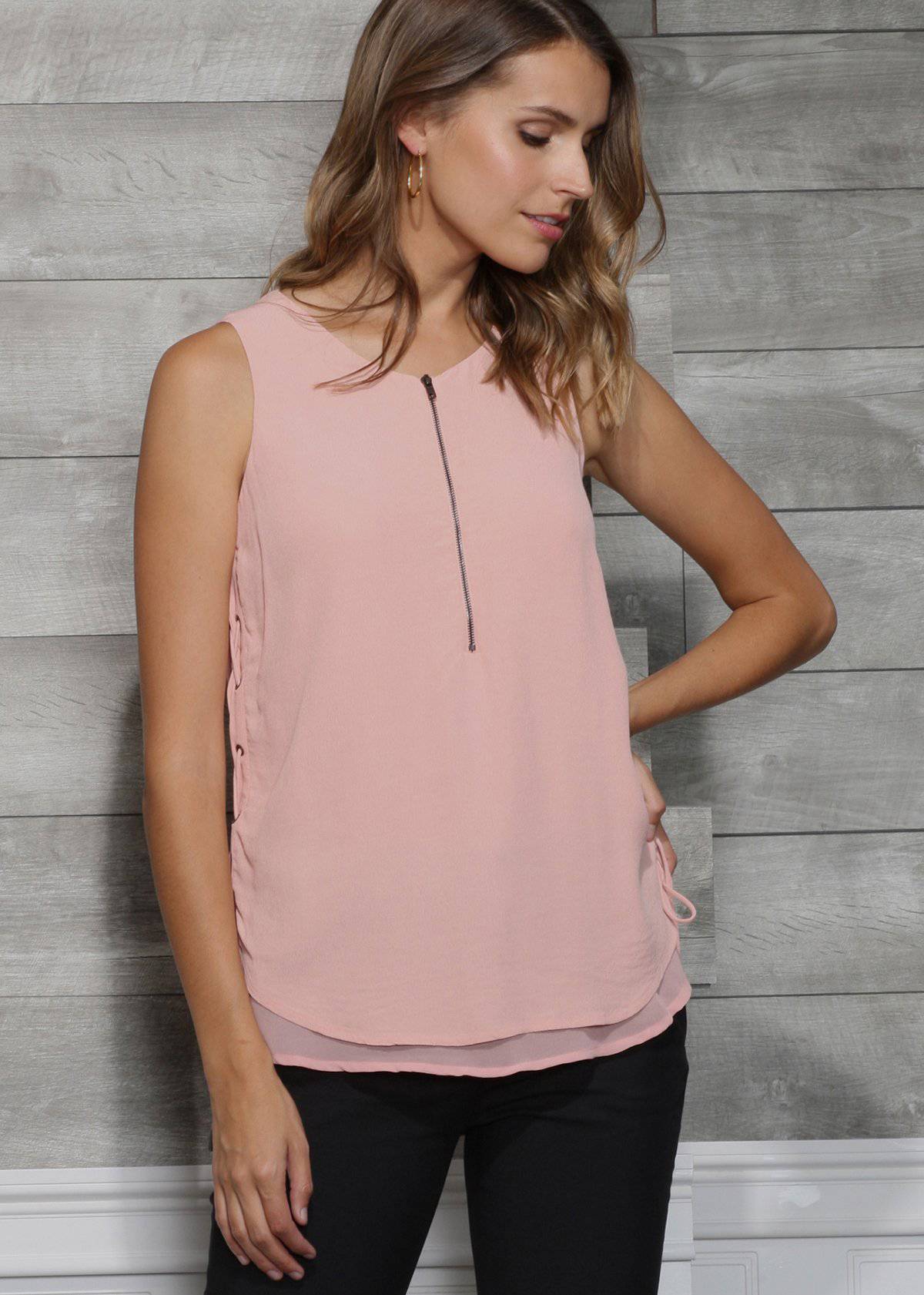 Women's sleeveless side tie blouse in peach apricot with crewneck and layered hem, featuring a lace-up side tie and zipper front.