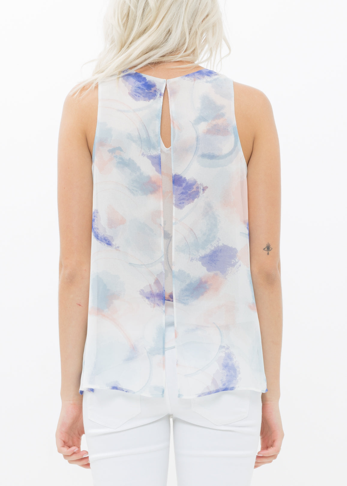 A stylish women's sleeveless blouse featuring a vibrant water color pattern and elegant slit detail, perfect for layering or solo wear.