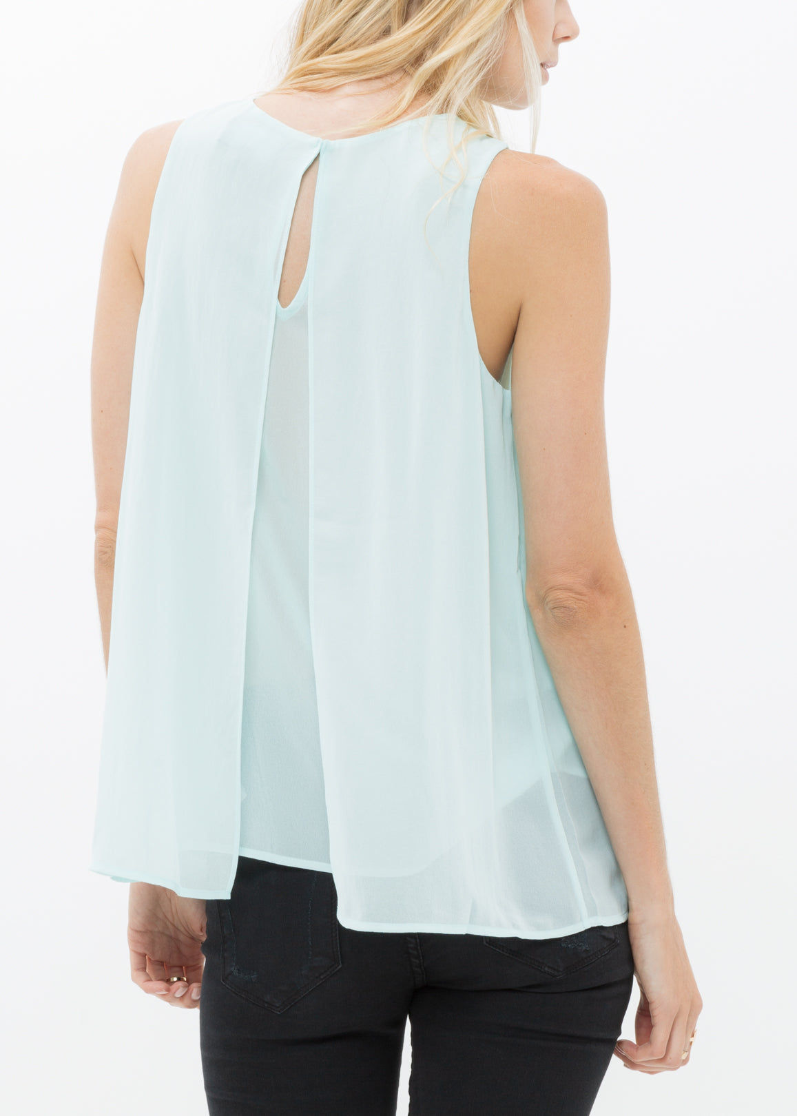 A stylish Women's Sleeveless Slit Blouse featuring a chic design with a slit and button back closure, made from 100% polyester.