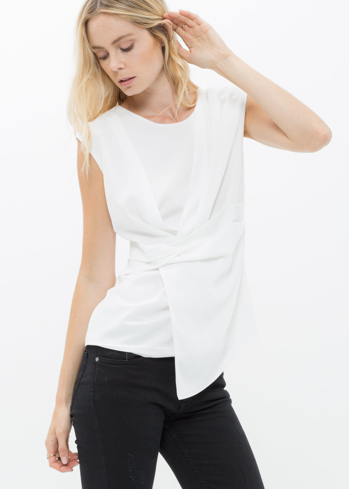 Women's sleeveless wrap blouse in ivory with back zip design, showcasing a chic and casual style.