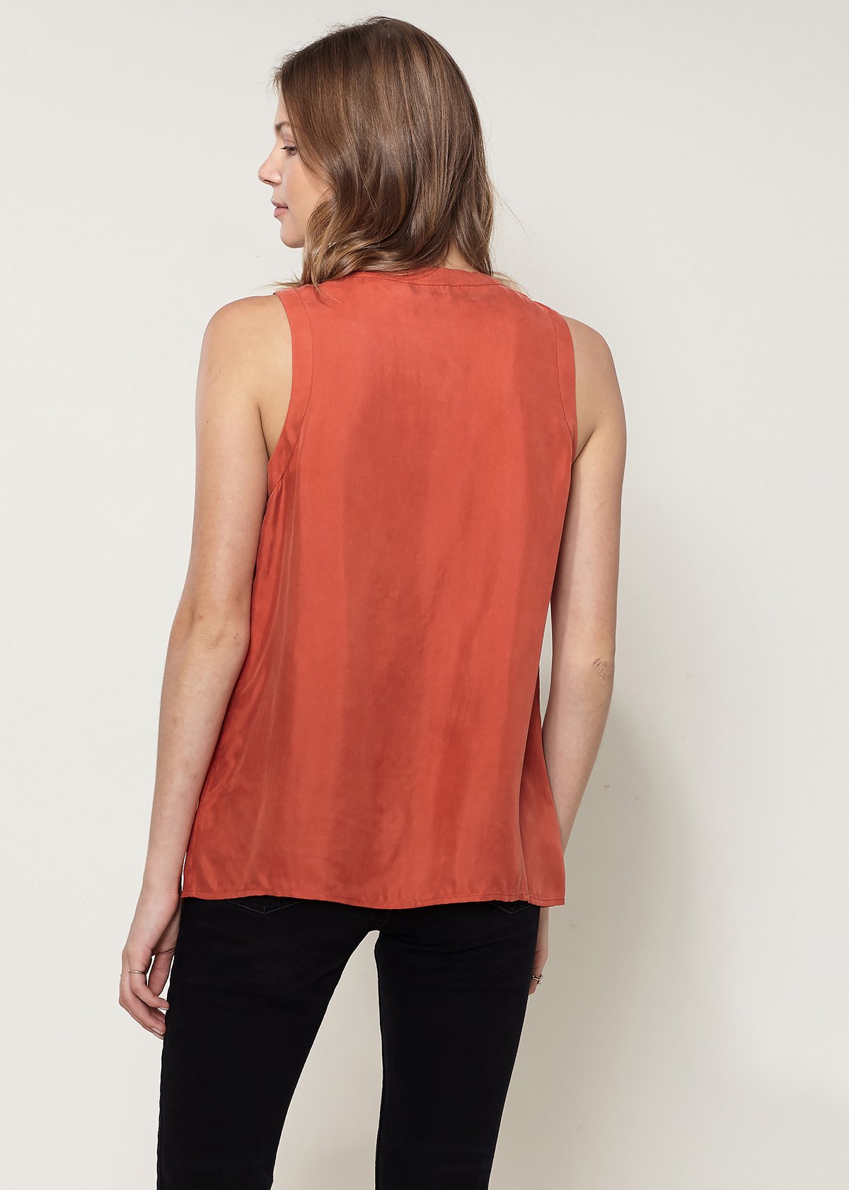 A stylish women's sleeveless top featuring a zip-up front, made from a soft cupro and viscose blend, perfect for casual wear.