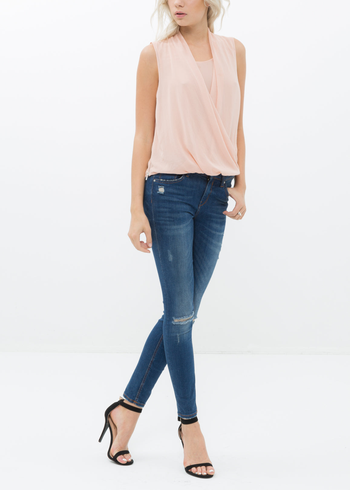 Women's Surplice Sleeveless Blouse in Blush, featuring a stylish design with button back closure and side zip.