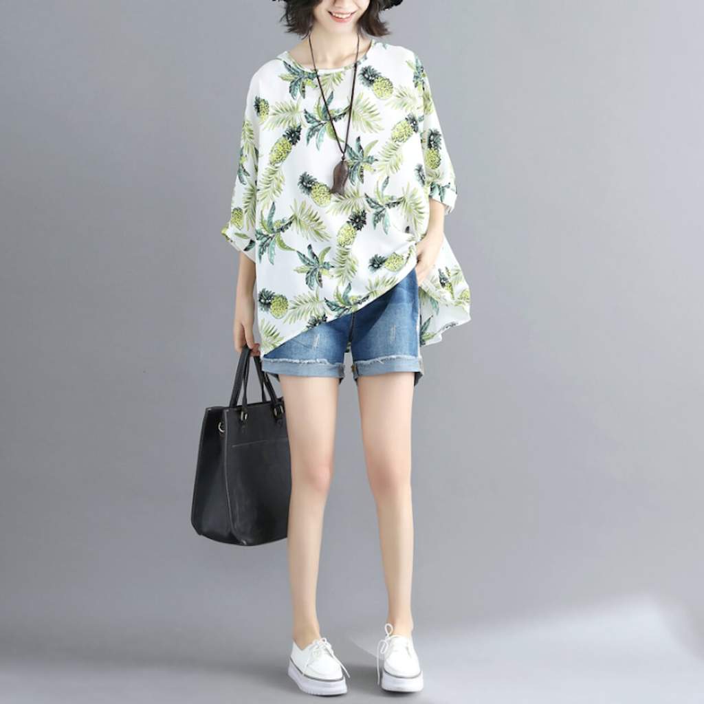 Womens Tropical Pineapple Print Batwing Top featuring a vibrant pineapple design on a white background, showcasing its loose fit and batwing sleeves.