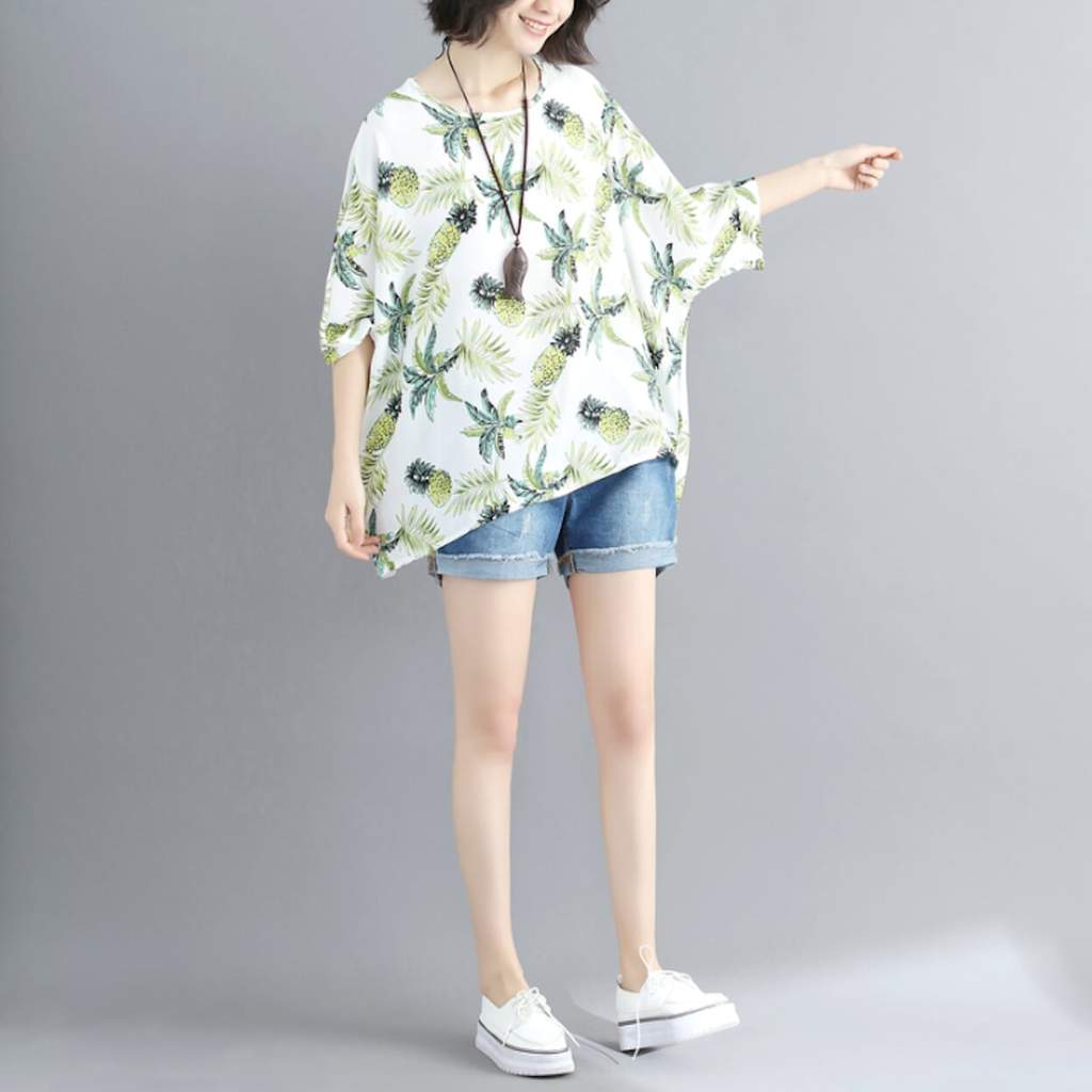 Womens Tropical Pineapple Print Batwing Top featuring a vibrant pineapple design on a white background, showcasing its loose fit and batwing sleeves.