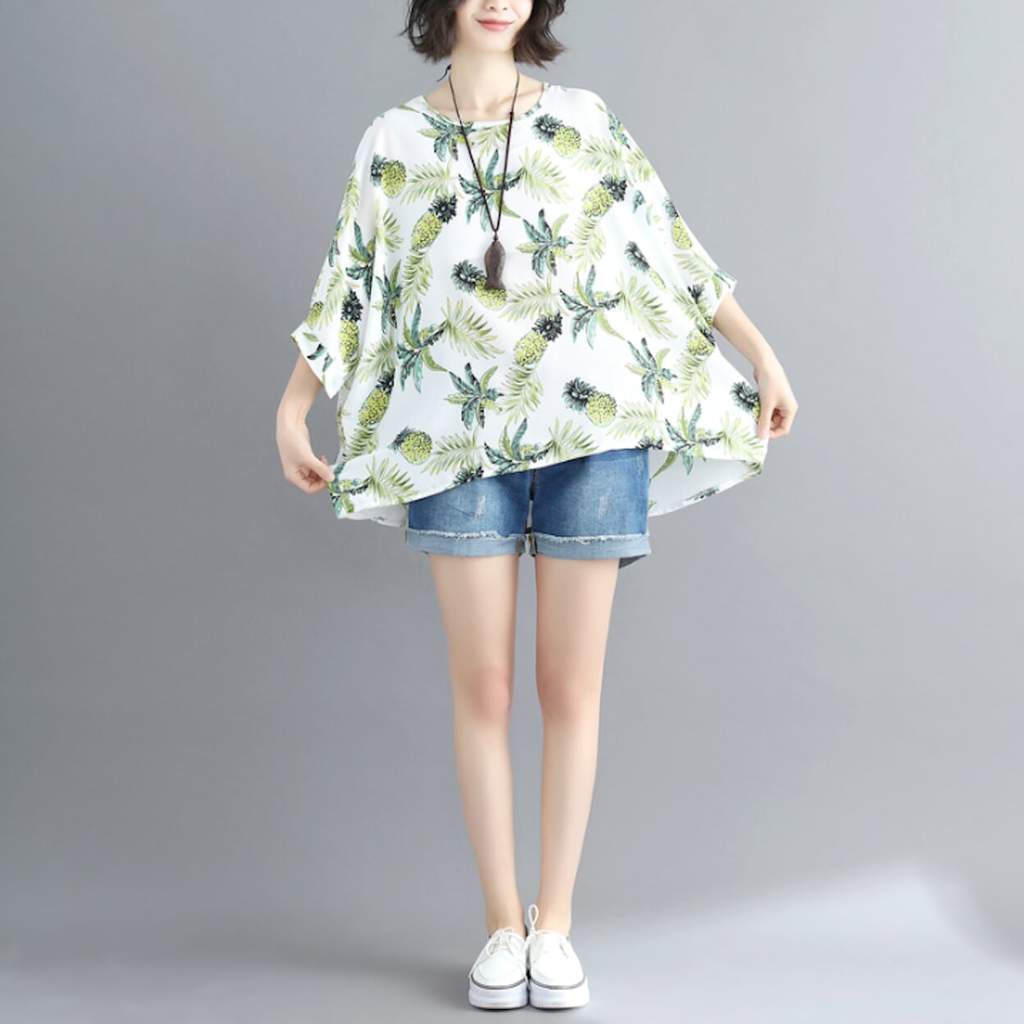 Womens Tropical Pineapple Print Batwing Top featuring a vibrant pineapple design on a white background, showcasing its loose fit and batwing sleeves.