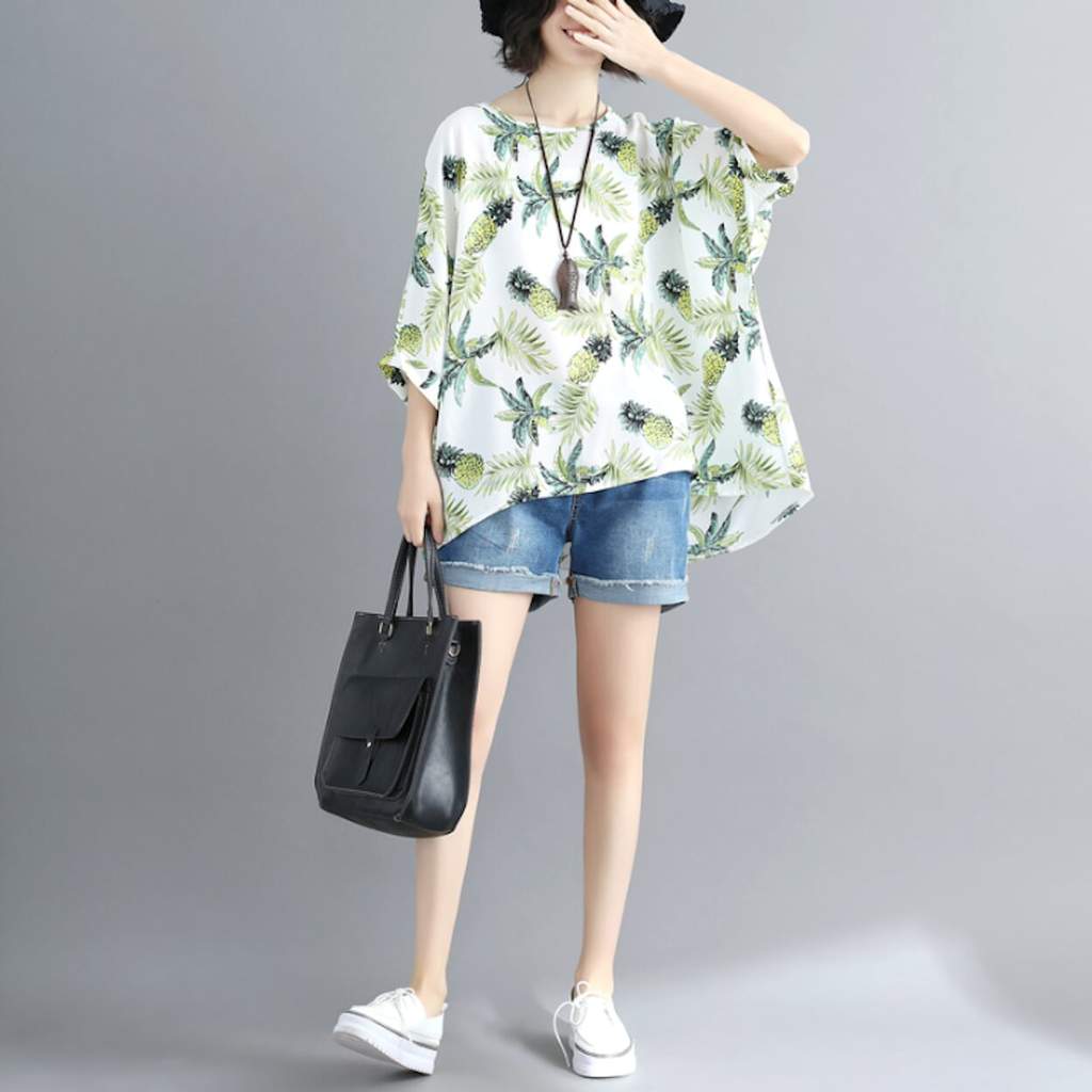 Womens Tropical Pineapple Print Batwing Top featuring a vibrant pineapple design on a white background, showcasing its loose fit and batwing sleeves.