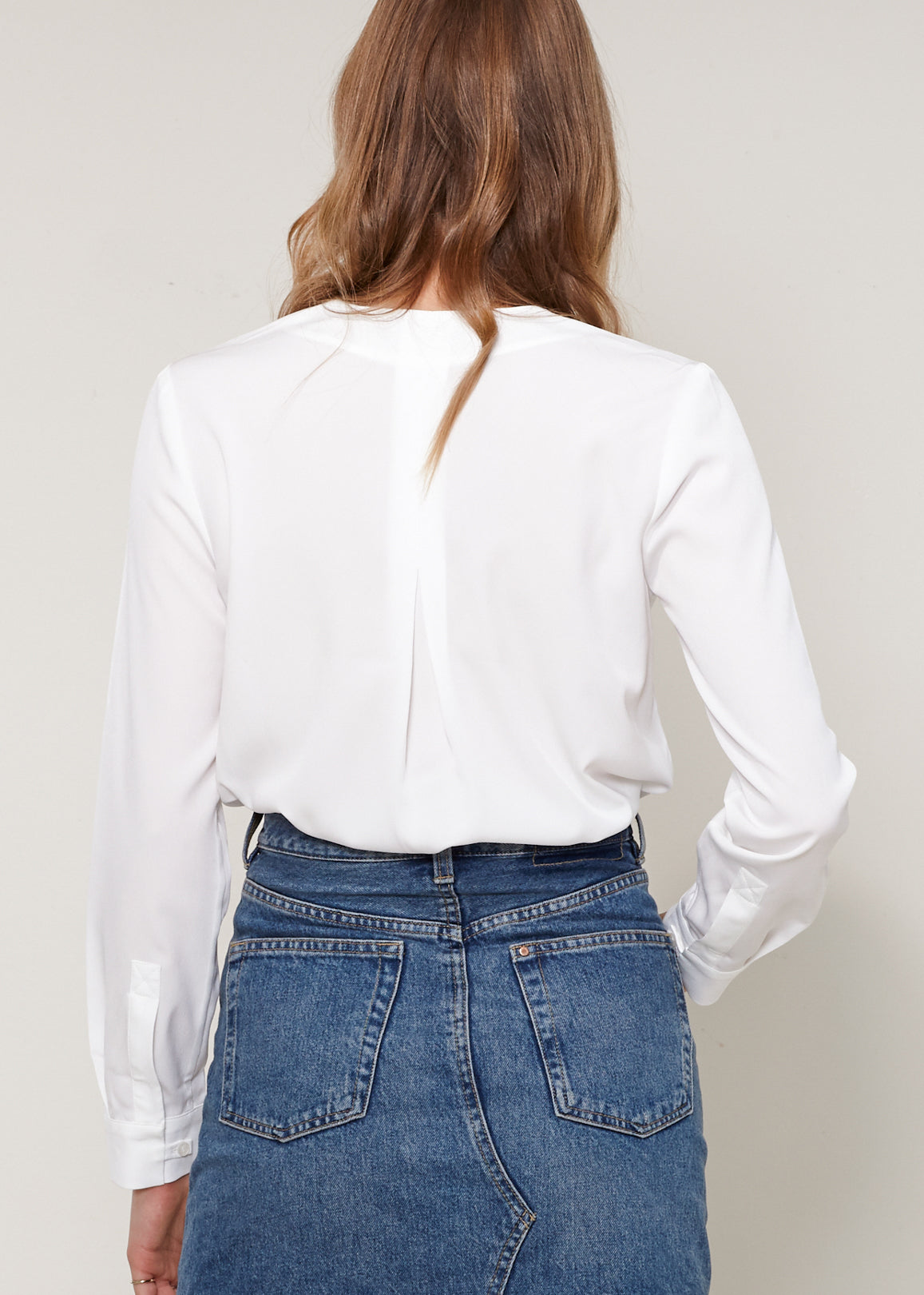 A stylish Women's V-neck Blouse made from 100% polyester, showcasing its elegant neckline and lightweight fabric.