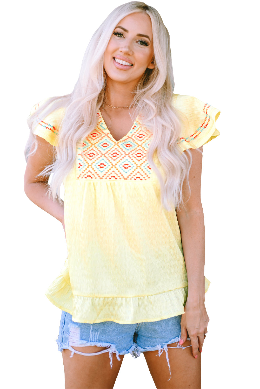 A stylish yellow top featuring geometric embroidery and ruffles, perfect for fashion-forward women.