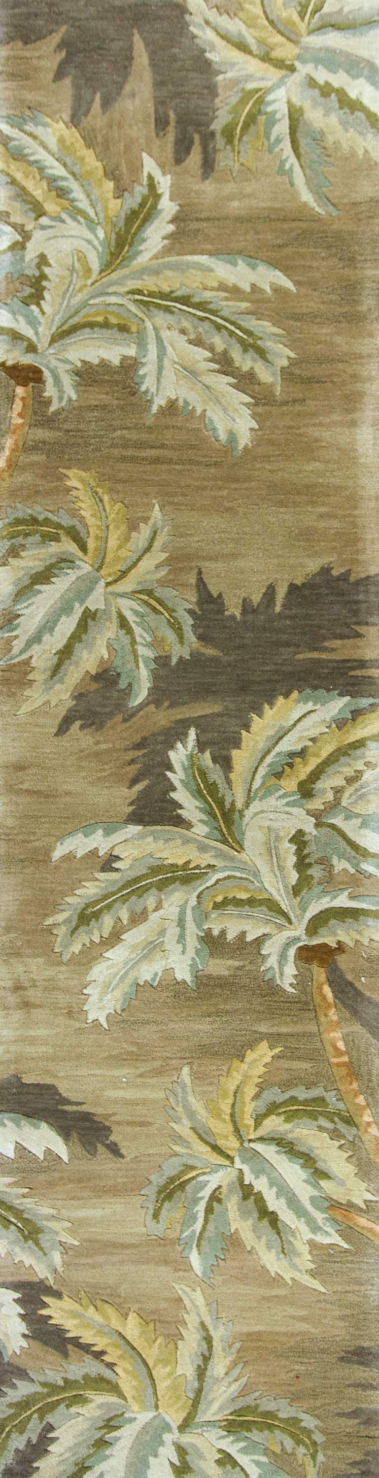 10' moss green hand-tufted indoor runner rug featuring tropical tree designs, made of wool with cotton backing.