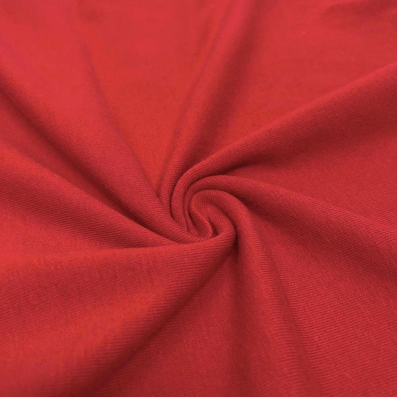 1/2 yard of vibrant red cotton jersey knit fabric, showcasing its soft texture and stretch.