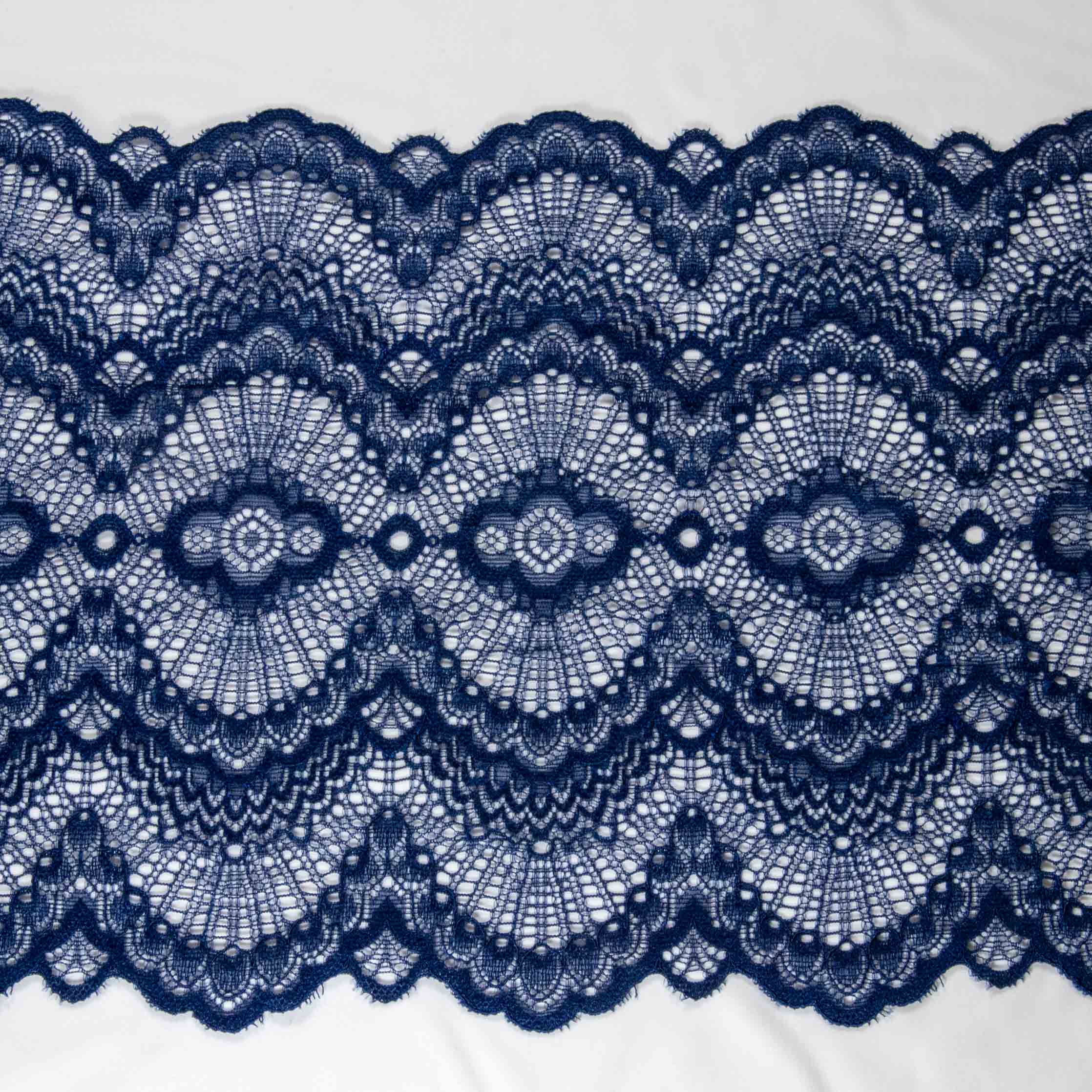 1/2 yard of blue double edge stretch scallop lace, showcasing intricate embroidered mesh design and scalloped edges.