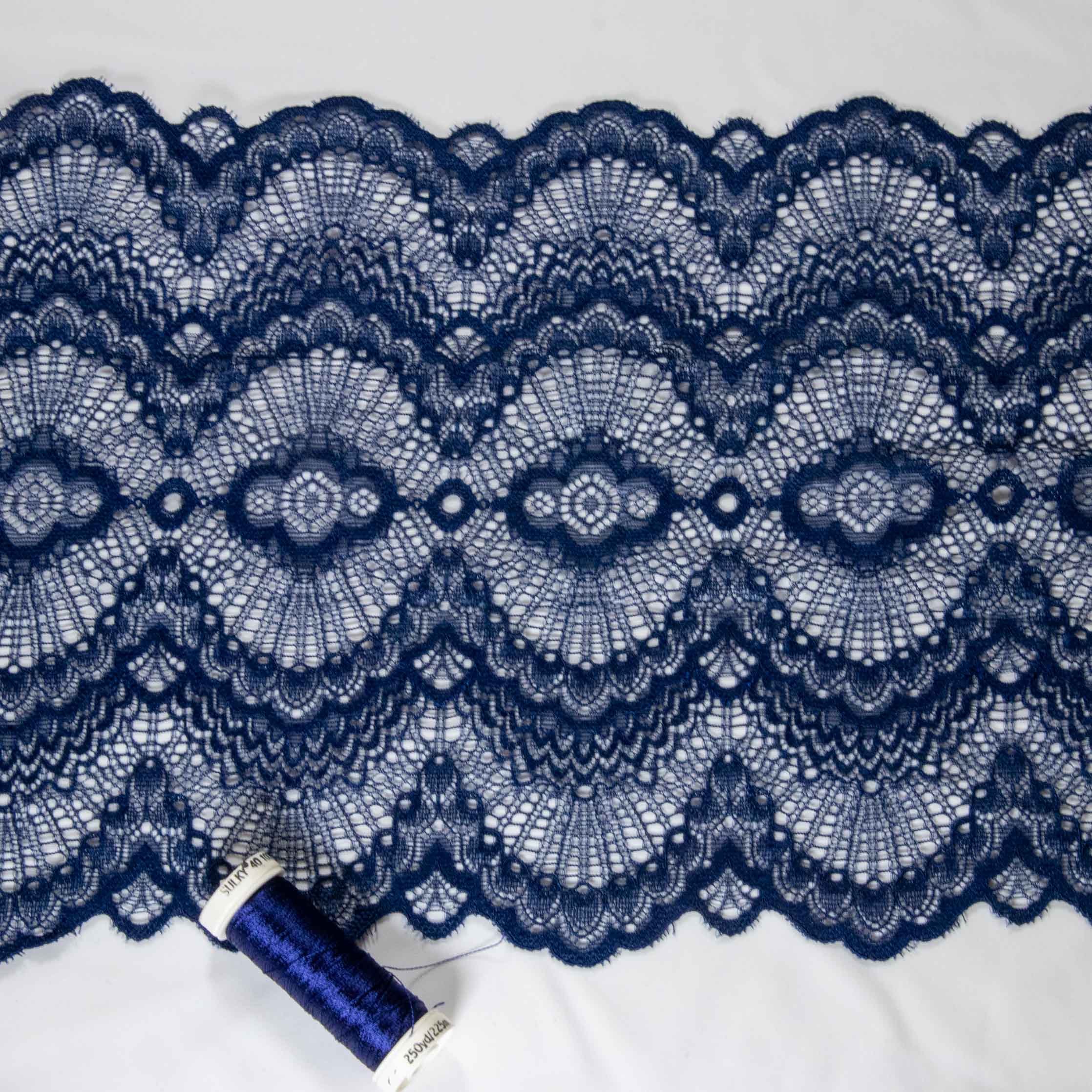 1/2 yard of blue double edge stretch scallop lace, showcasing intricate embroidered mesh design and scalloped edges.