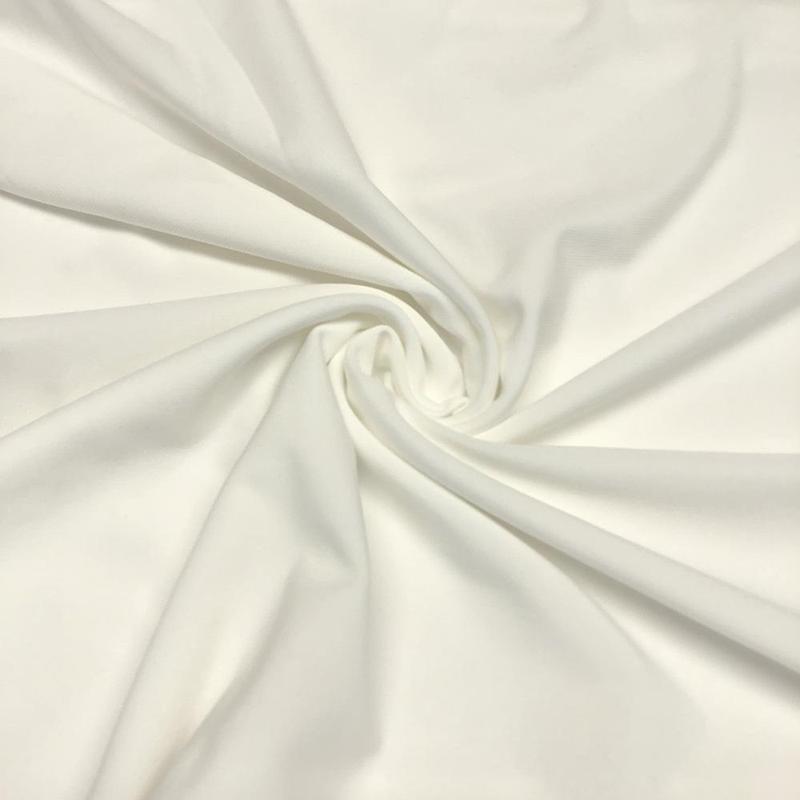 1/2 yard of ITY knit fabric in Off White, showcasing its soft texture and stretch.