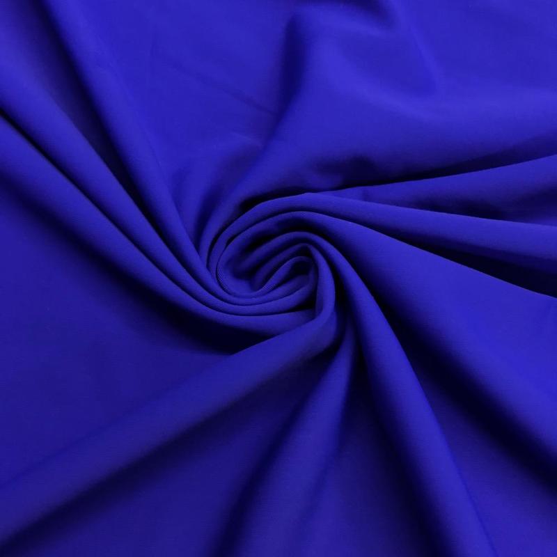 A vibrant blue 1/2 yard of nylon tricot fabric, showcasing its soft and stretchy texture, ideal for various sewing projects.