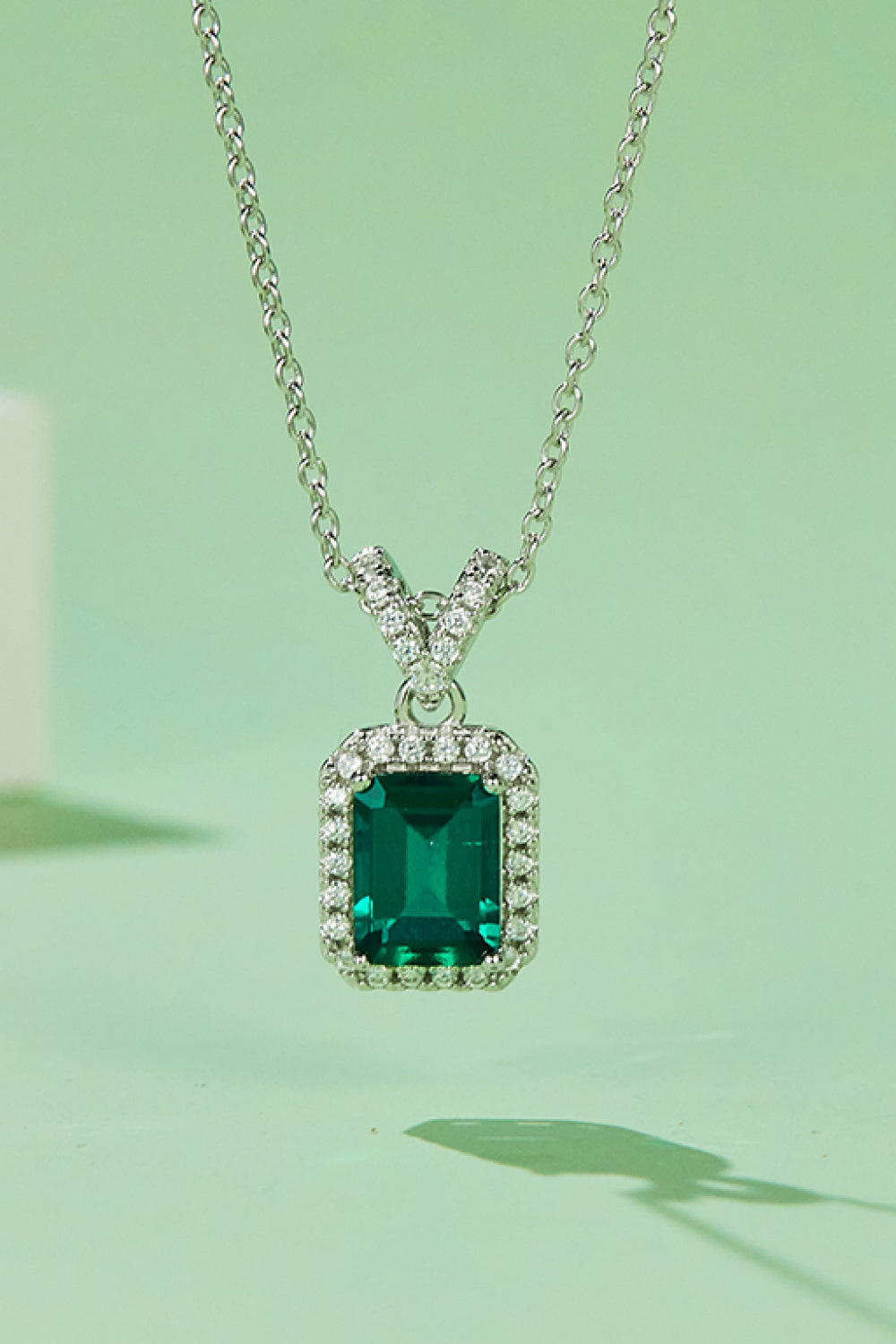 Elegant 1.25 carat lab-grown emerald pendant necklace in platinum-plated sterling silver, displayed in a matching gift box.