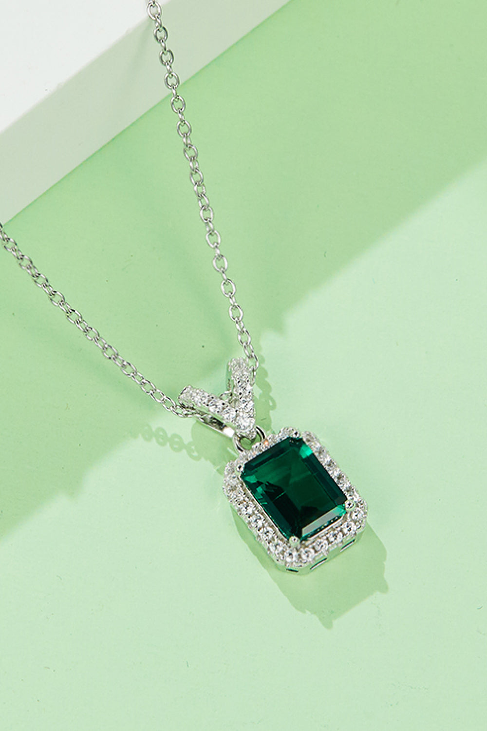 Elegant 1.25 carat lab-grown emerald pendant necklace in platinum-plated sterling silver, displayed in a matching gift box.