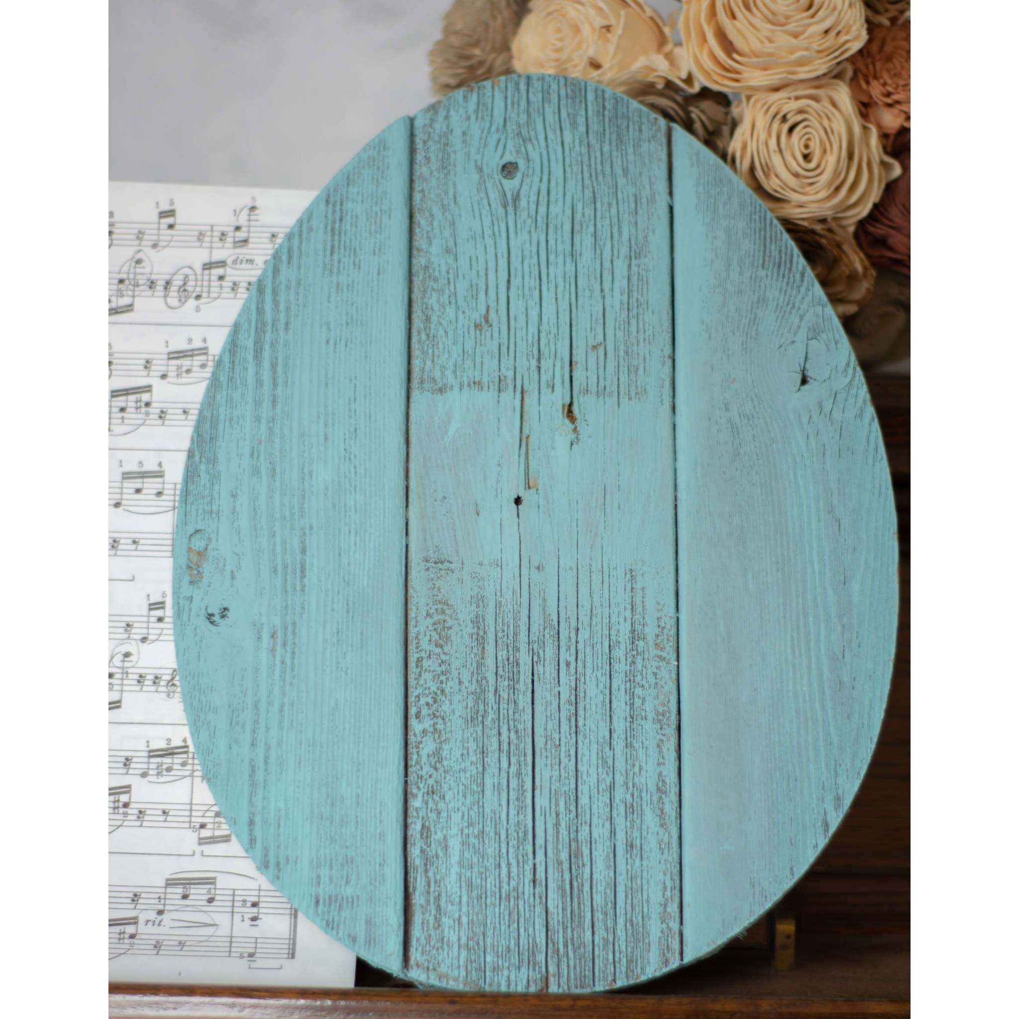 A 12-inch turquoise wooden egg with a distressed finish, crafted from reclaimed cedar, perfect for decorative use and crafting.