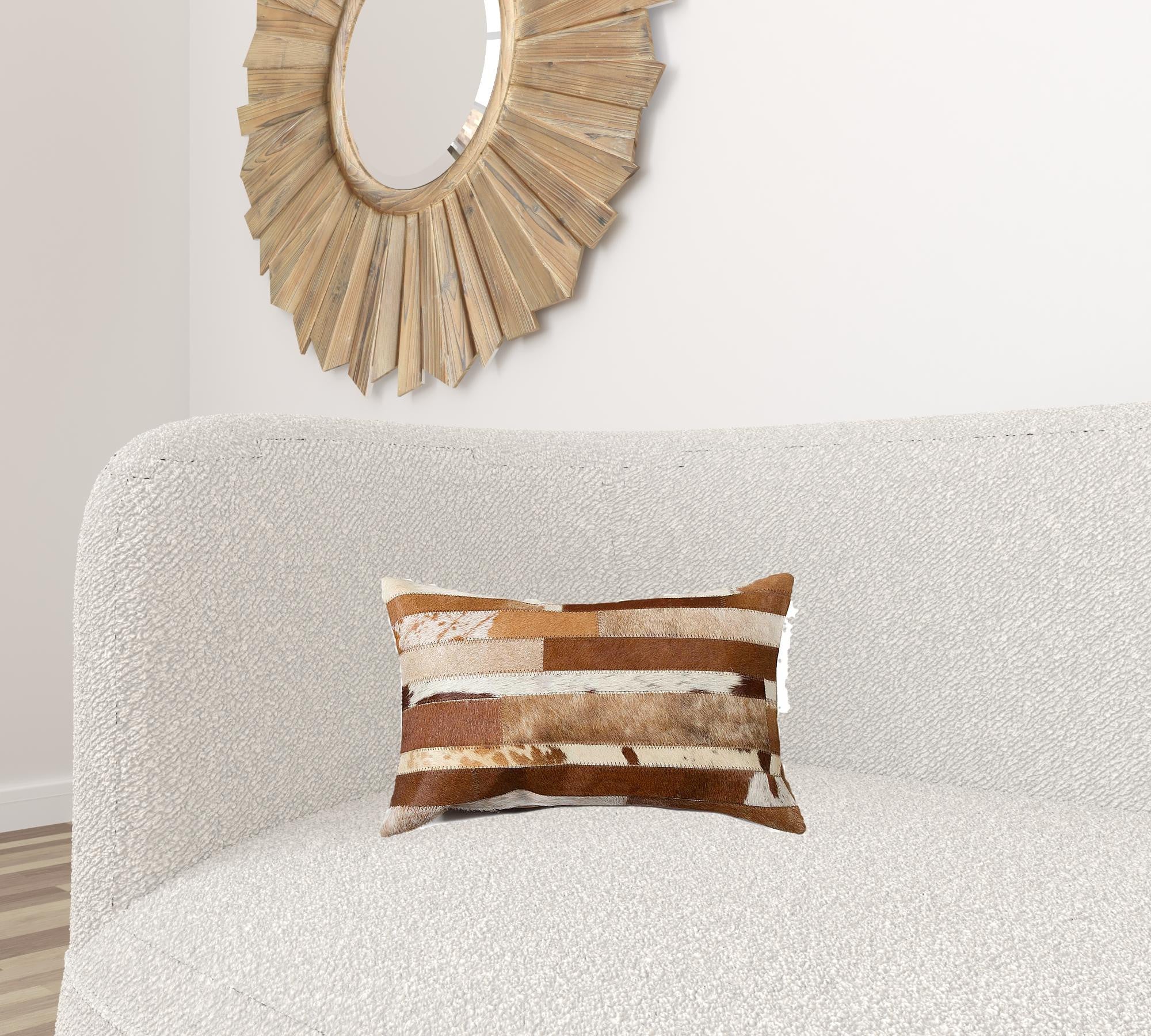 A luxurious gray pillow made from premium Indian cowhide, featuring a soft microsuede backing and concealed zipper closure.