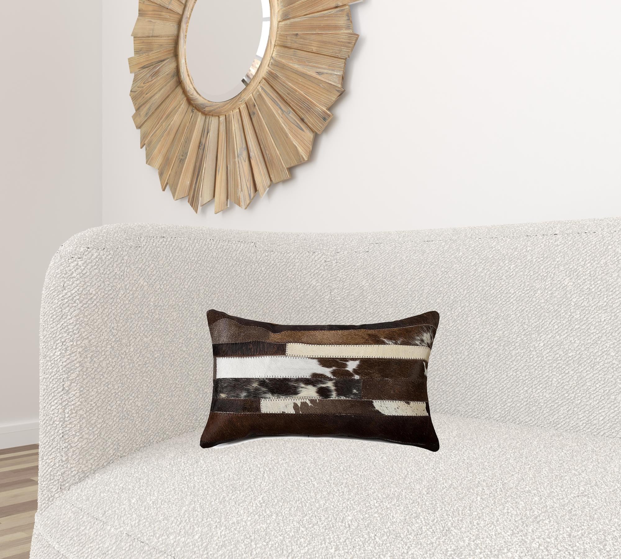 A luxurious gray pillow made from premium Indian cowhide, featuring a soft microsuede backing and concealed zipper closure.