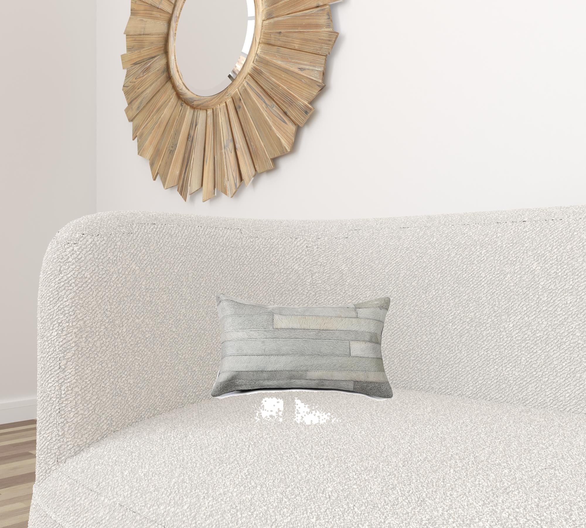 A luxurious gray pillow made from premium Indian cowhide, featuring a soft microsuede backing and concealed zipper closure.