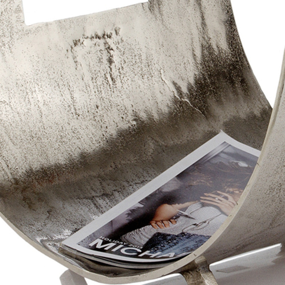 A stylish raw silver magazine basket with a modern design, perfect for organizing magazines and enhancing home decor.