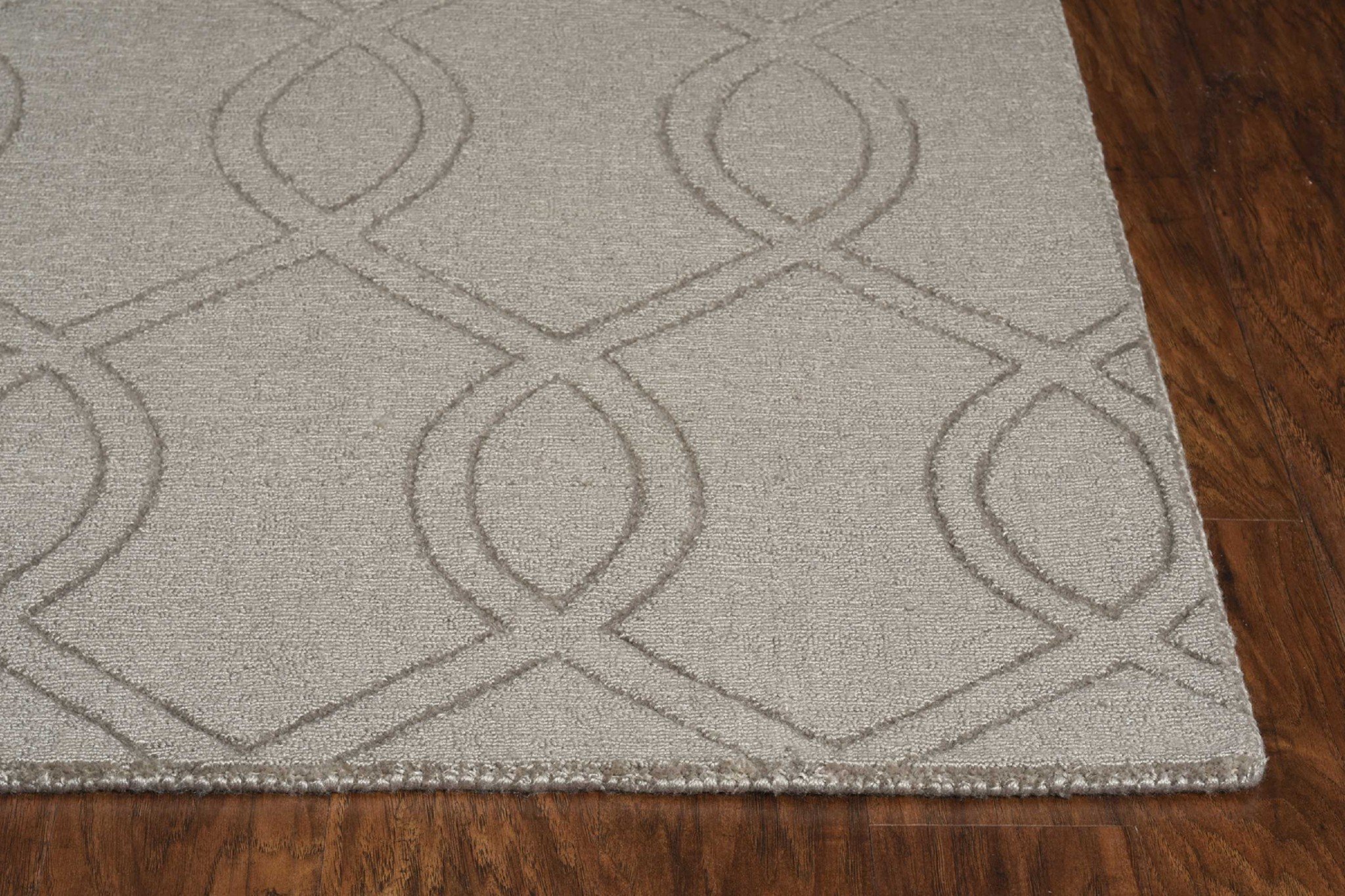 A 17" X 90" taupe polyester rug featuring elegant embossed patterns, perfect for enhancing home decor.