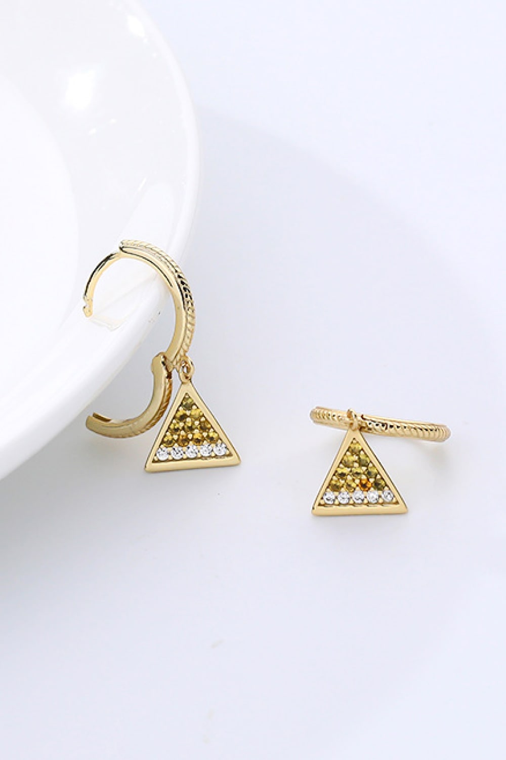 Elegant 18K gold plated cubic zirconia triangle drop earrings showcasing a modern geometric design.