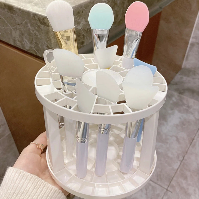 A sleek and polished plastic makeup brush storage stand, designed to hold various sizes of brushes securely and stylishly.