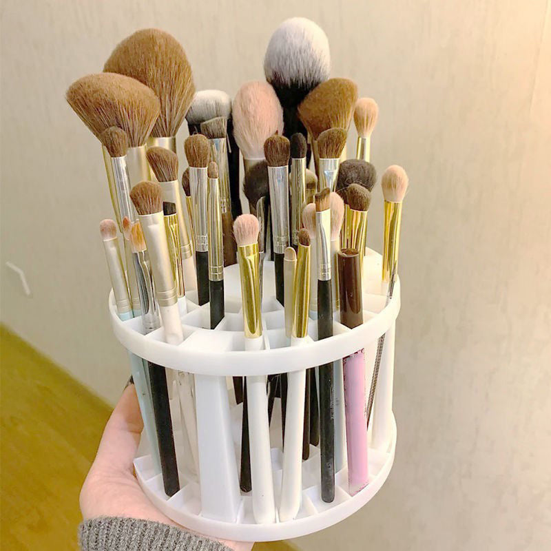 A sleek and polished plastic makeup brush storage stand, designed to hold various sizes of brushes securely and stylishly.