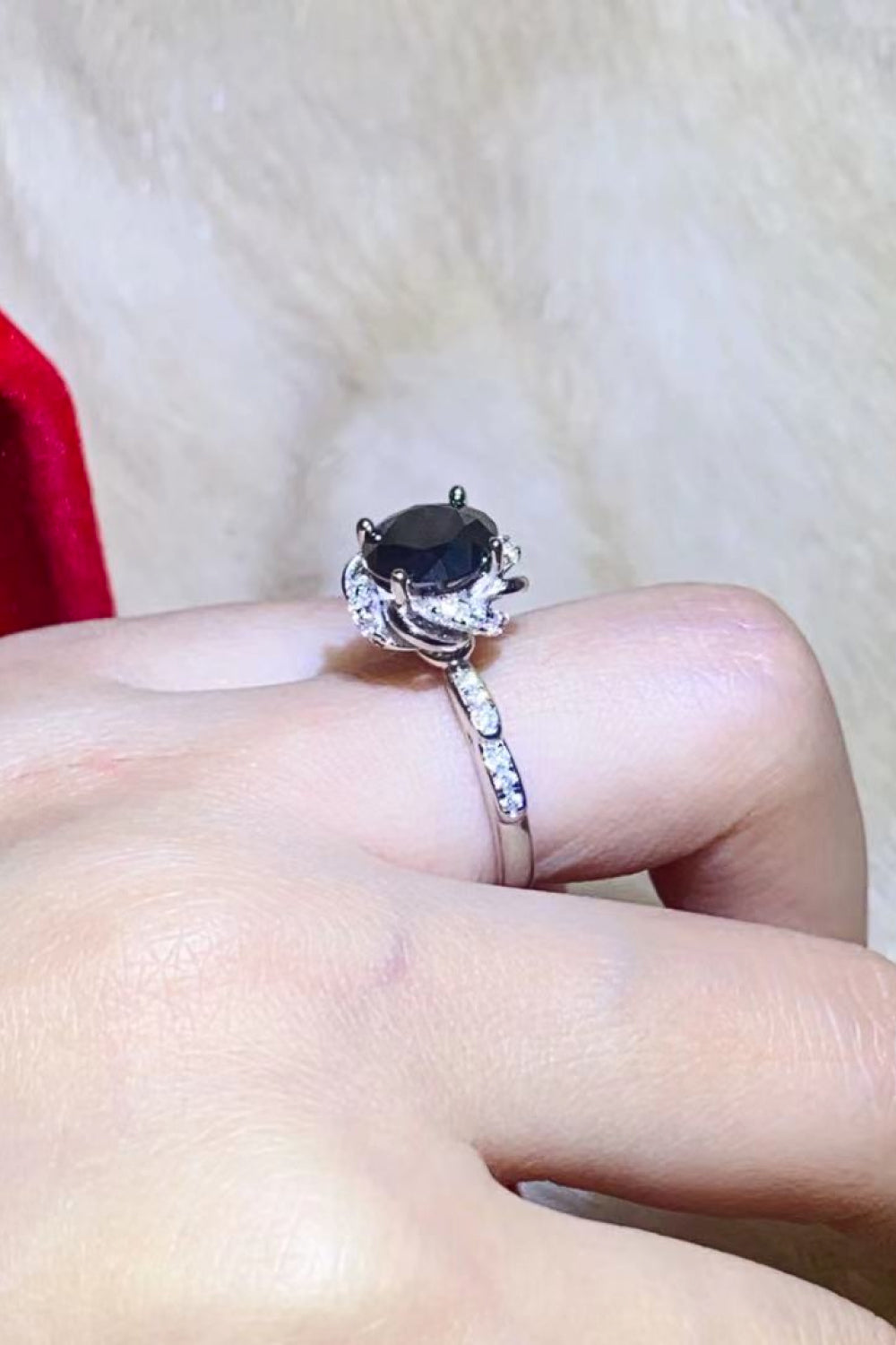 A beautiful 2 Carat Black Moissanite Floral Ring displayed in a flat lay style, showcasing its modern minimalist design and sparkling moissanite stone.