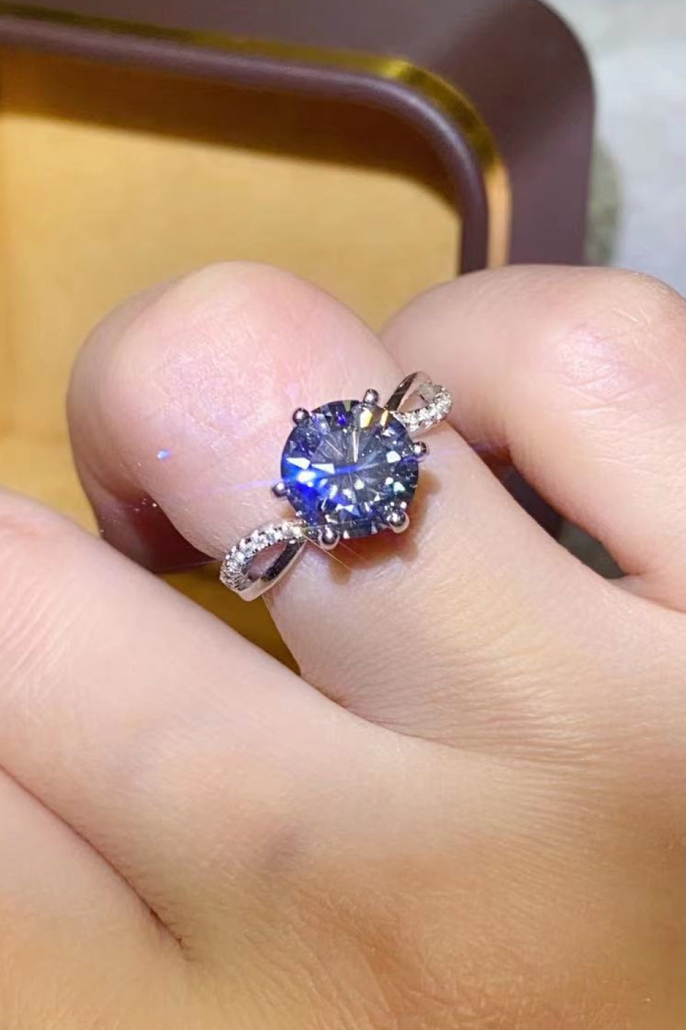 A stunning 2 Carat Moissanite Ring in Smokey Gray, featuring a round moissanite stone set in polished 925 sterling silver, displayed in a studio flat lay.