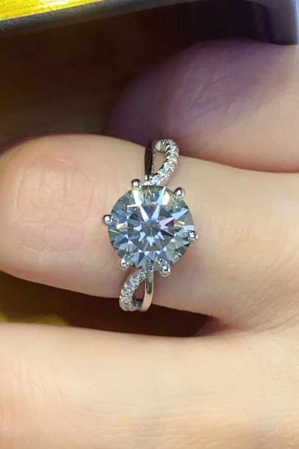 A stunning 2 Carat Moissanite Ring in Smokey Gray, featuring a round moissanite stone set in polished 925 sterling silver, displayed in a studio flat lay.