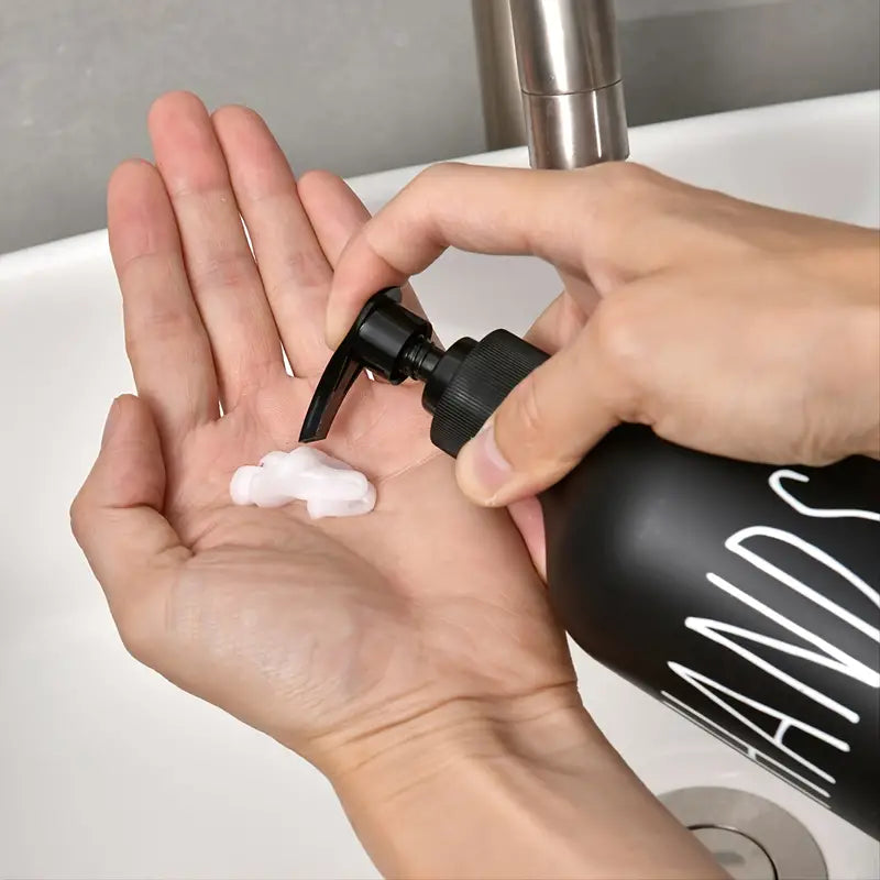 Two matte black soap dispensers with pumps, ideal for hand and dish soap, showcasing a sleek and modern design.