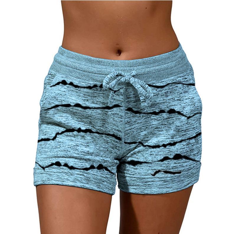 A pair of stylish women's quick-drying shorts with a striped pattern, perfect for yoga and casual sports.