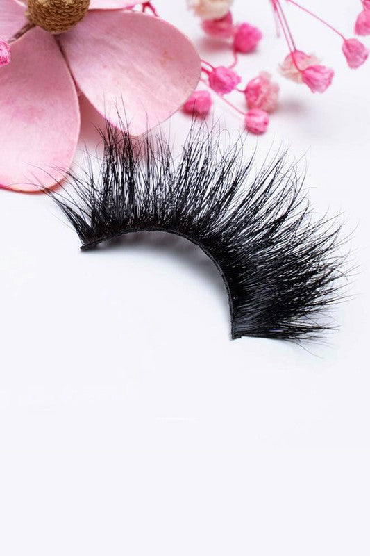 A pair of 25mm dramatic volume mink eyelashes displayed in elegant packaging, showcasing their fluffy texture and round eye shape.