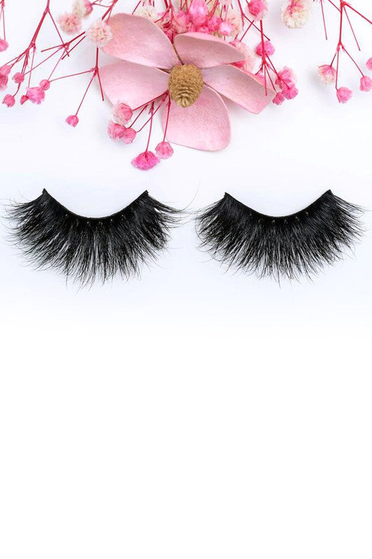 A pair of 25mm dramatic volume mink eyelashes displayed in elegant packaging, showcasing their fluffy texture and round eye shape.