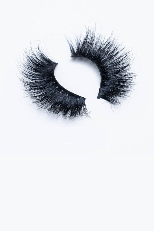 A pair of 25mm dramatic volume mink eyelashes displayed in elegant packaging, showcasing their fluffy texture and round eye shape.