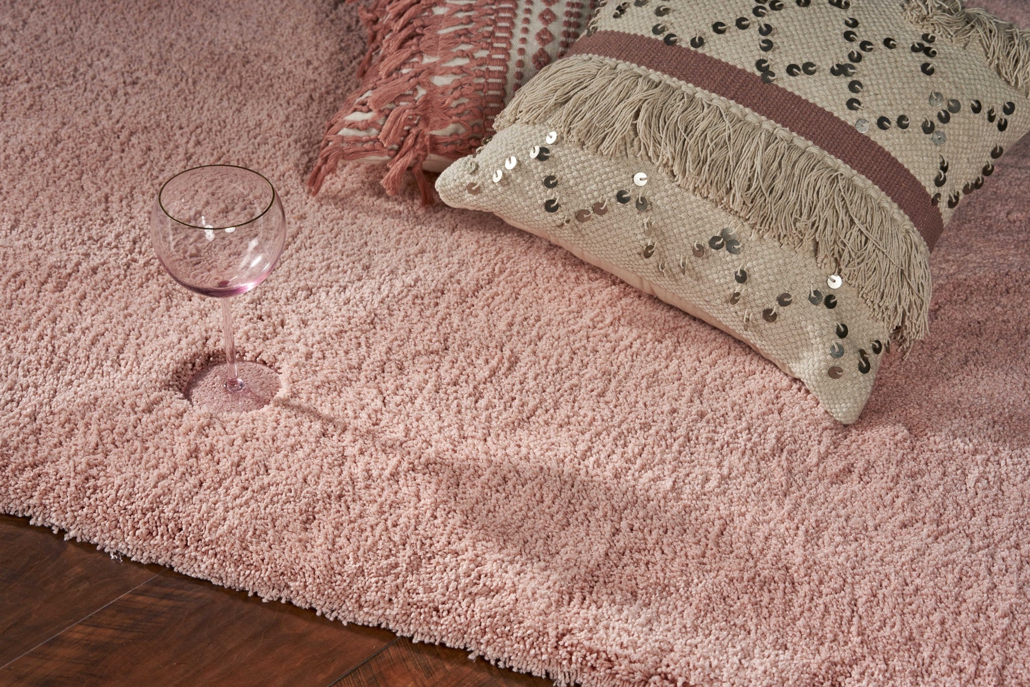 A beautiful 2x4 inches rose pink shag area rug, hand woven from high-grade polyester with a soft texture, perfect for contemporary home decor.