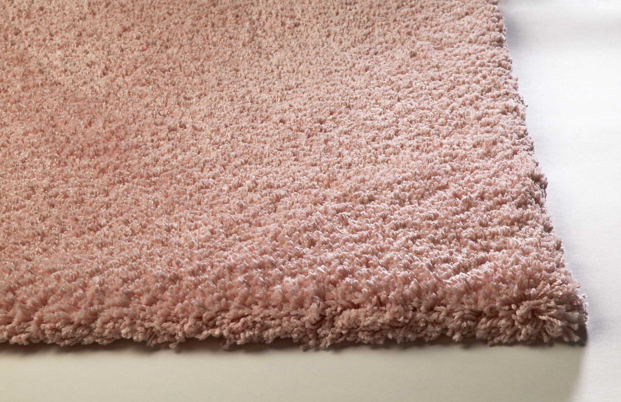 A beautiful 2x4 inches rose pink shag area rug, hand woven from high-grade polyester with a soft texture, perfect for contemporary home decor.