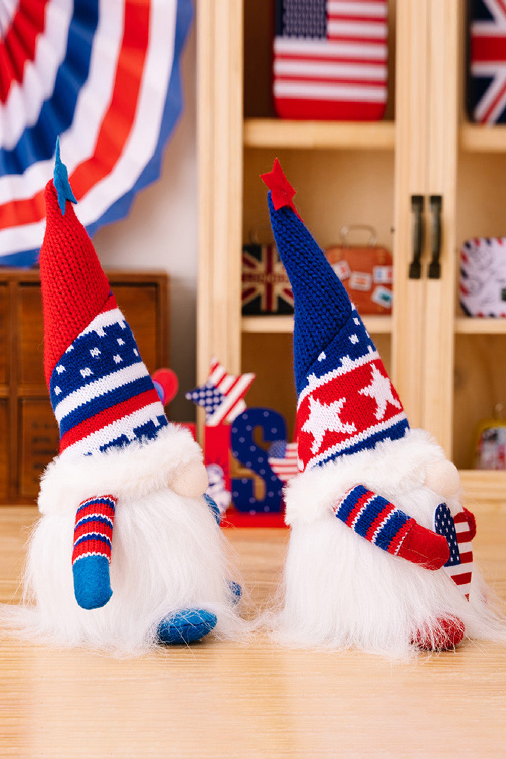 Two charming Independence Day gnomes made of knit fabric, featuring festive colors and designs, perfect for holiday decor.