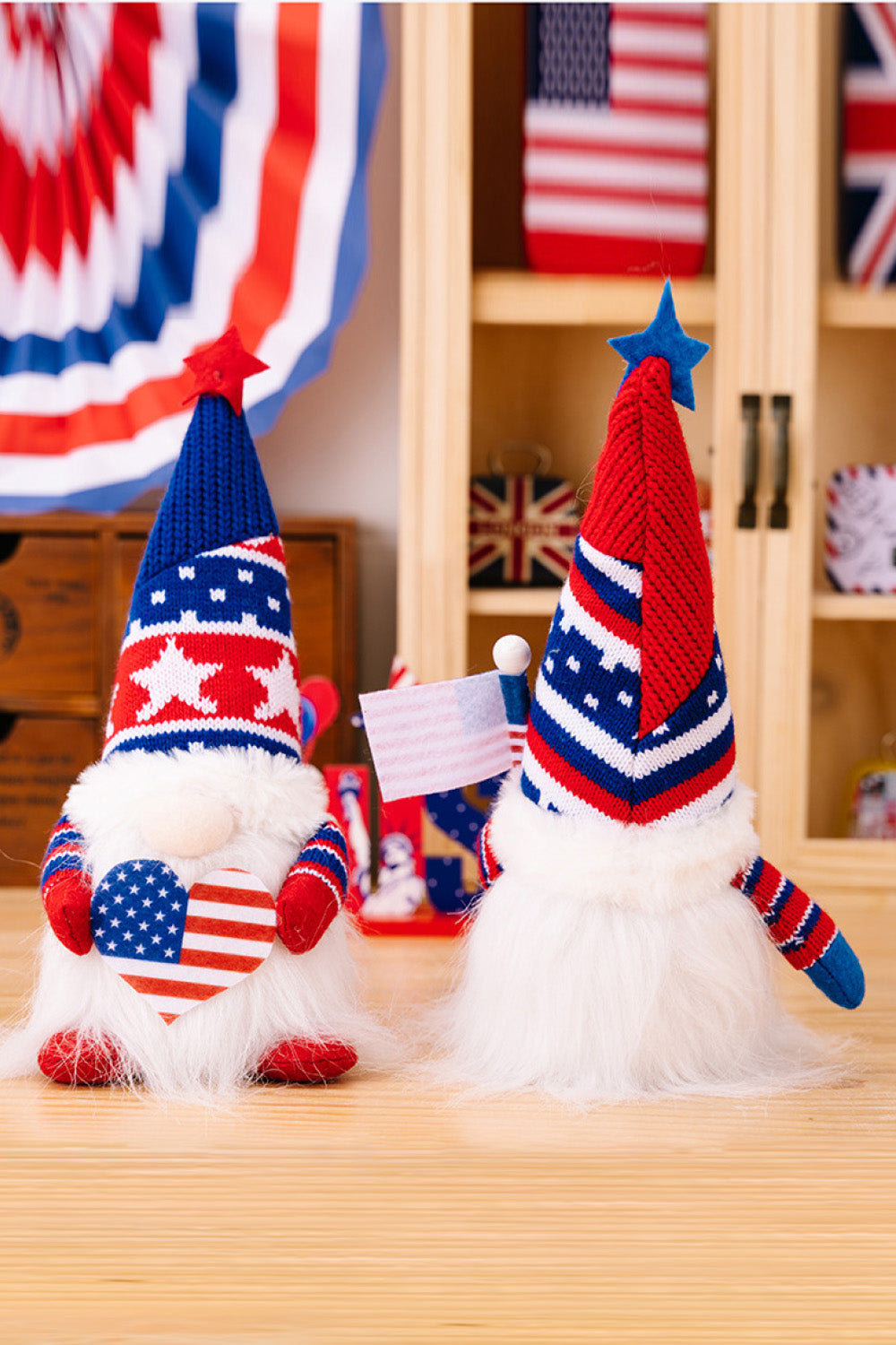 Two charming Independence Day gnomes made of knit fabric, featuring festive colors and designs, perfect for holiday decor.